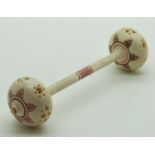 A 19thC Indian Madras ware ivory baby's rattle in the form of a dumbell, length 12.5cm
