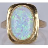 A 9ct gold ring set with a synthetic opal, 3.8g, size M/N