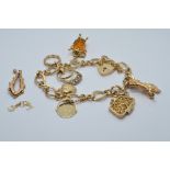 A 9ct gold charm bracelet with various charms including a purse, 'i love you' , rings, etc , 28g