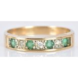 A 9ct gold ring set with alternating emeralds and diamonds, 2.3g, size O