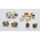 A collection of 9ct gold earrings including a white gold pair set with a pearl, emerald and