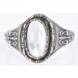 A silver ring set with a moonstone and scale symbols to the shoulders, 1.9g, size N