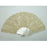 A 19thC mother of pearl and lace fan, width 41cm