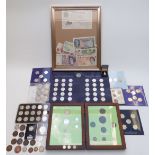 An amateur collection of coins and banknotes, some framed, including a white £5 note, coins