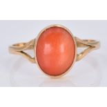 An 18ct gold ring set with a coral cabochon, 1.7g, size M