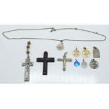 A silver crucifix, other crosses and gold plated pendants