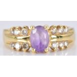An 18ct gold ring set with an amethyst and diamonds, 4.1g, size M