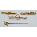 A 15ct gold brooch set with three rubies (2.1g),a 15ct gold stick pin set with a sapphire and seed