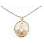 A double sided Edwardian locket (2.5 x 3cm) with 9ct gold edge, Birmingham 1904, on a 9ct gold