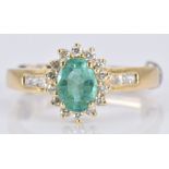 An 18k gold ring set with an oval emerald and diamonds, 3.6g, size K
