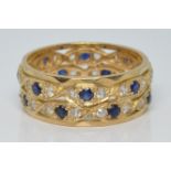 A 9ct gold eternity ring set with a sapphires and cubic zirconia, 4.7g, size P/Q