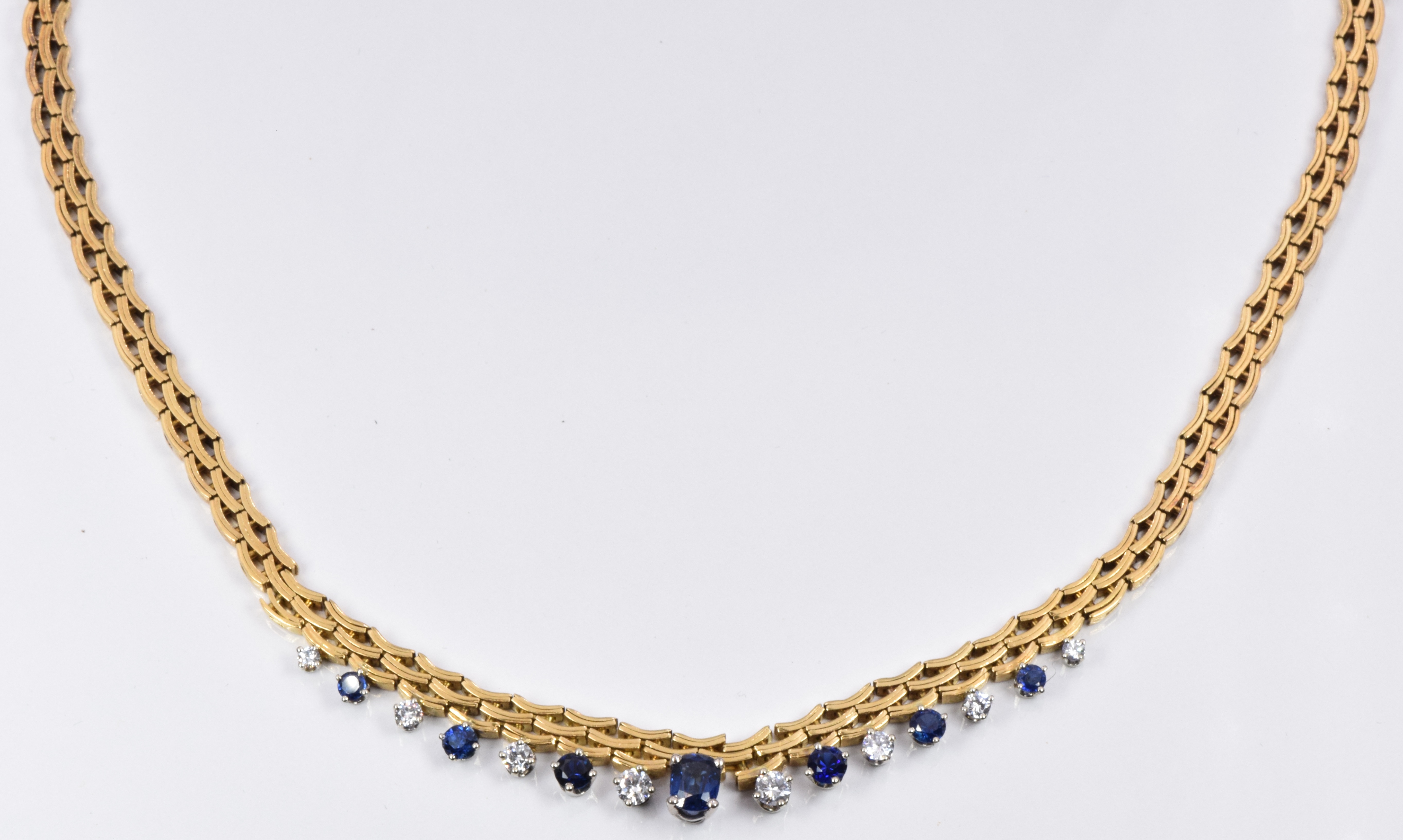 Gubelin 18ct gold necklace set with an oval cut sapphire of approximately 0.68ct, six round cut