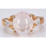 A 9ct gold ring set with a morganite cabochon and diamonds, 5.2g, size M