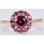 A 9ct gold ring with a rhodalite garnet and amethysts, 2.1, size N