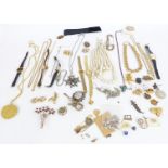 A collection of costume jewellery including Trifari necklace, silver identity bracelet, silver