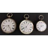 Three silver open faced pocket watches all with black Roman numerals and white enamel dials, largest