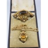 Victorian brooch set with a citrine within a filigree border (W- 3.5cm x L- 5cm), and a similar
