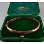 Edwardian 9ct gold bangle with engraved ivy decoration, Birmingham 1900, 7.3g, in vintage R Lloyd,