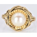An 18ct gold ring set with a pearl, 4.3g, size M/N