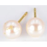 A pair of yellow metal earrings set with pearls