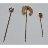 A 9ct gold stick pin set with a diamond, a Victorian yellow metal stick pin in the form of a horse