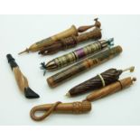 A collection of treen needle cases including Mauchline Ware parasol, deer slot, riding crop, straw