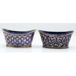 Pair of Victorian hallmarked silver open salts with pierced decoration and blue glass liners, London