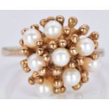 A 9ct gold ring set with pearls in a stylised setting, 4.9g, size P