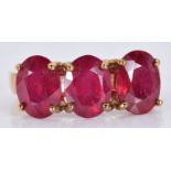 A 9ct gold ring set with three oval rubies, 3.7g, size J