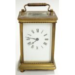 Brass carriage clock with Roman enamelled dial, corniche corners to case and movement stamped '