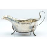 George V hallmarked silver sauce boat with shaped edge, raised on three pad feet, Sheffield 1934