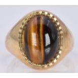 A 9ct gold ring set with tiger's eye cabochon, 9.6g, size T