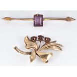 A 9ct gold brooch set with garnets in the form of a stylised bouquet and another 9ct gold brooch,