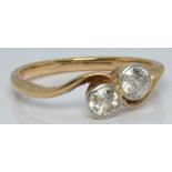 A yellow metal ring set with two diamonds, each approximately 0.2ct in a twist setting, 2.0g, size K