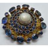 Austro-Hungarian silver gilt brooch set with a pearl and foiled gemstones, diameter 2.5cm