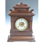 Ansonia oak cased mantel clock, with Arabic ivory coloured enamel chapter ring, beetle and poker