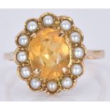 A 9ct gold ring set with an oval cut citrine surrounded by pearls, 4.2g, size R