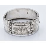 A hallmarked silver Victorian bangle bracelet with engraved floral decoration and jewelled edge (