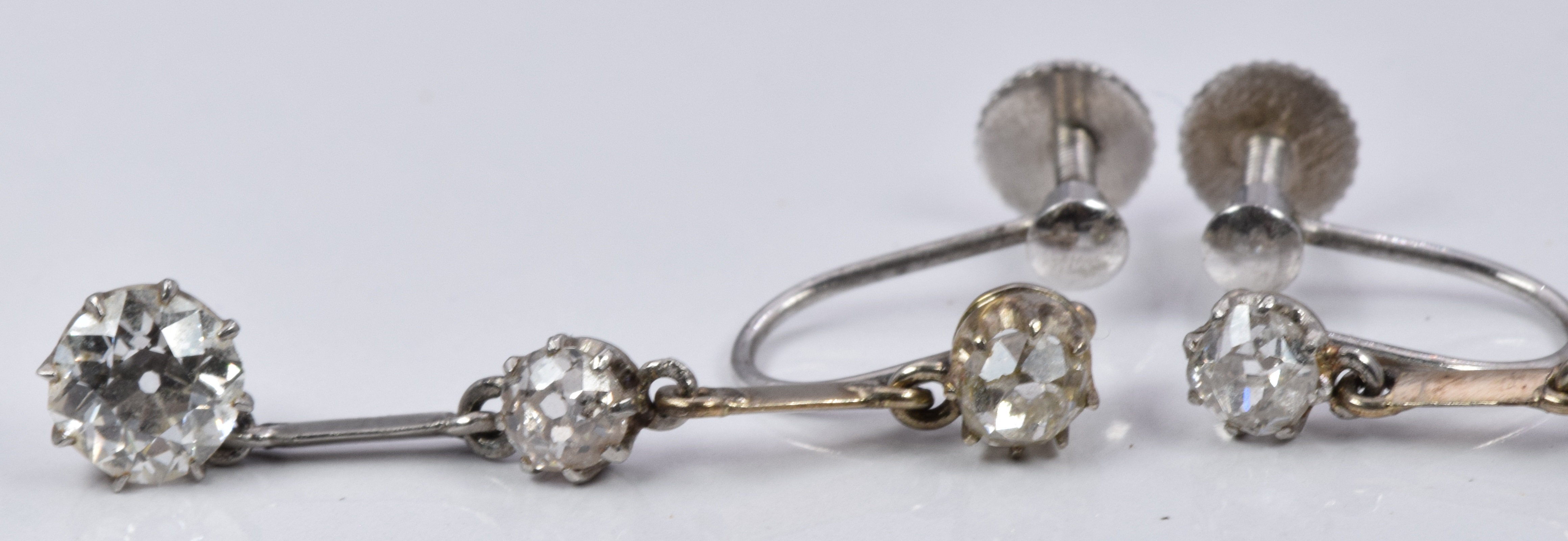 A pair of Art Deco 9ct white gold earrings set with three old cut diamonds, the largest - Image 3 of 4
