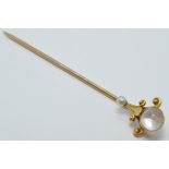 A continental 14k gold stick pin set with a moonstone and seed pearl, length 6cm, 2.1g