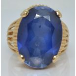 A 14ct gold ring set with a synthetic sapphire, 8.6g, size M