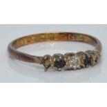 An 18ct gold ring set with a diamond and two sapphires, London 1864, 1.5g, size L/M