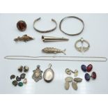 A collection of silver jewellery including bangles, ring set with agate, brooch, locket,