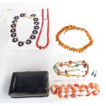 A pressed amber necklace, a coral necklace set with graduated round beads, two beaded agate