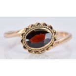 A 9ct gold ring with a garnet, 1.6g, size K