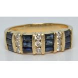 A 14k gold ring set with baguette cut sapphires and round cut diamonds, 4.3g, size N