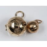 A 9ct gold football charm / pendant opening to reveal a player and a small football charm, 9.1g