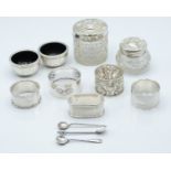 Two hallmarked silver mounted cut glass dressing table pots, hallmarked silver napkin rings, a