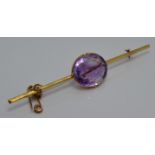 Edwardian yellow metal brooch set with a large oval amethyst of approximately 15ct, 9.3cm long