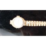 Rotary 9ct gold ladies wristwatch with gold hands and hour markers, silver dial and asymmetric case,